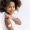 Close-up of African American cute little girl, preschooler, with band-aid on shoulder, received a vaccine, protection against covid19, and other diseases, stands on an isolated white background, smile